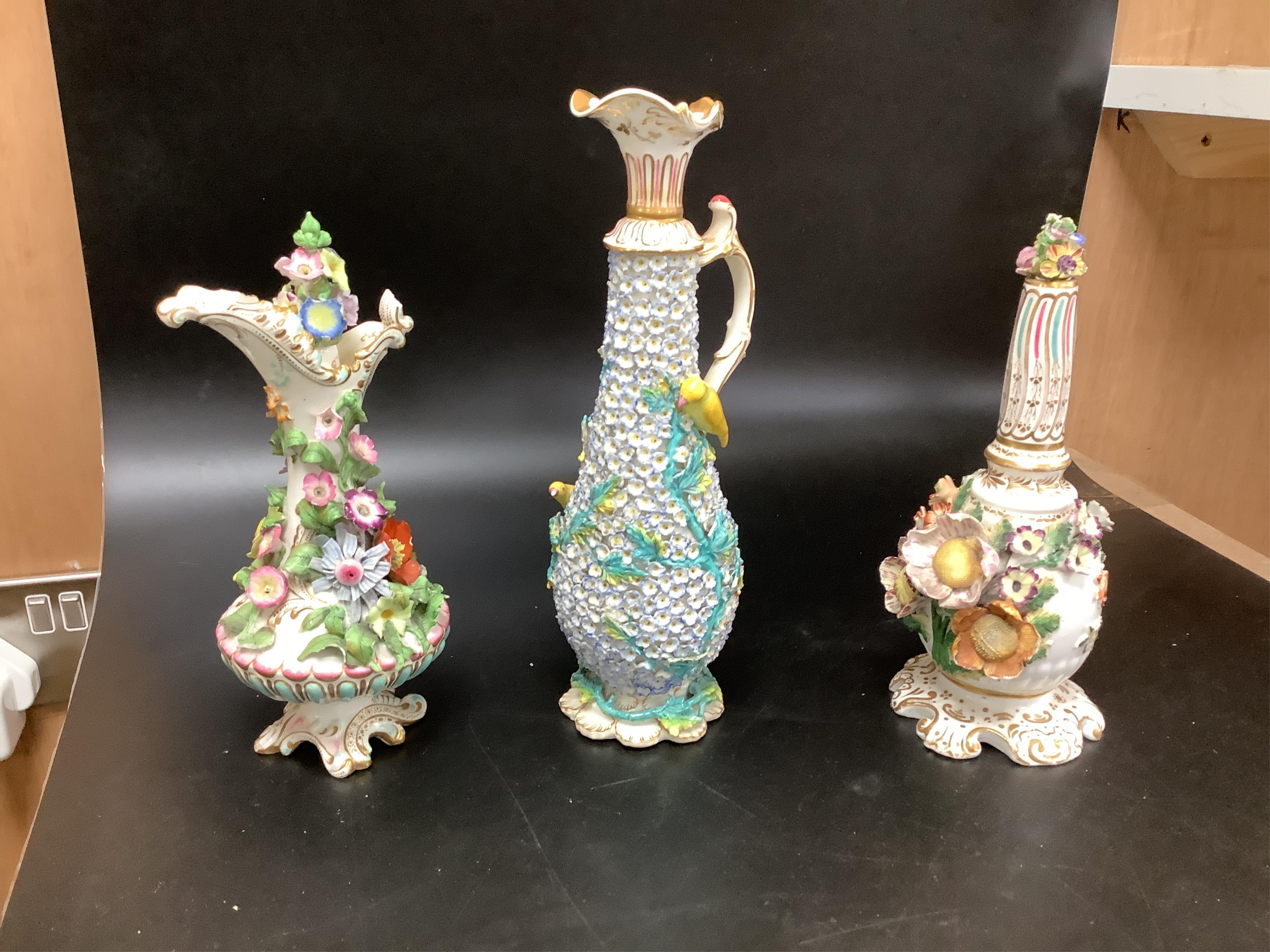 A group of English porcelain flower encrusted scent bottles and yours, Coalport, Minton etc., c.1830-50 together with Continental porcelain figures a wall pocket etc, largest 26cm high